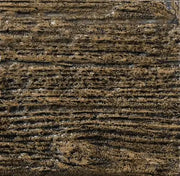 Close-up of a textured brown surface with visible grain